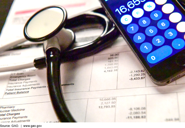 Photo of a stethoscope, calculator and patient medical bill
