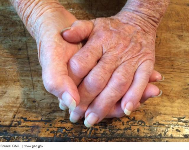 Photo of clasped, elderly hands