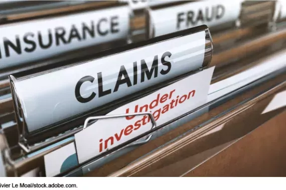 Photo showing a filing cabinet folders marked &quot;fraud,&quot; &quot;Insurance,&quot; Claims&quot; and &quot;Under Investigation&quot;