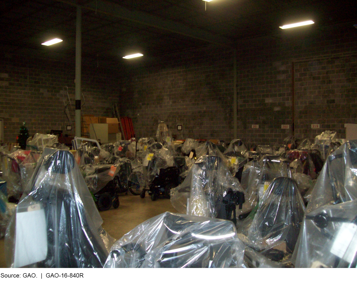 Photograph of wheelchairs and accessories awaiting distribution