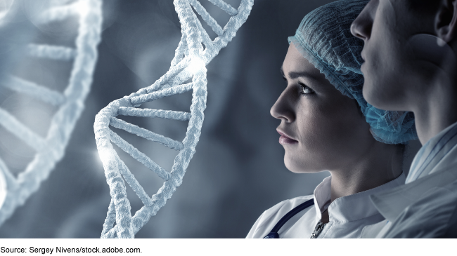 An image of two people in lab coats looking at a glowing illustration of DNA strands