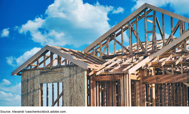 The wooden framework of a new house with the sky in the background