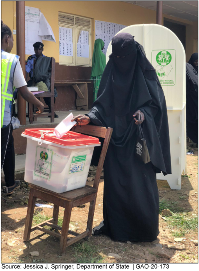 A person casts a vote in a ballot box in Nigeria