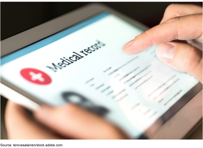 A person holding a tablet showing medical records. A person holding a tablet showing medical records.