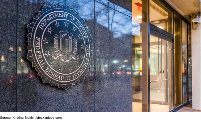 Picture of the FBI's seal on a wall outside of an office.