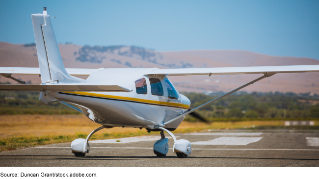 A small plane preparing to take off on an airport runway.