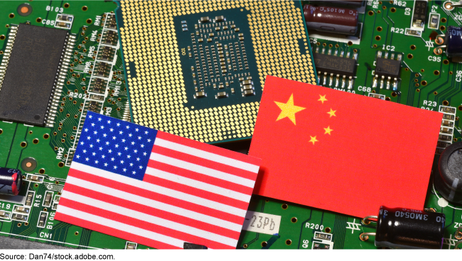 The U.S. flag and Chinese flag lie on top of a computer circuit board. The U.S. flag and Chinese flag lie on top of a computer circuit board.