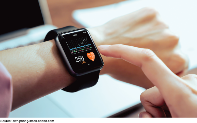 A closeup of a smartwatch on someone's wrist displaying heartrate and other data. A closeup of a smartwatch on someone's wrist displaying heartrate and other data.