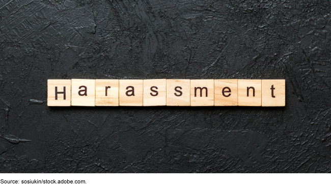 The word harassment spelled out in wooden blocks