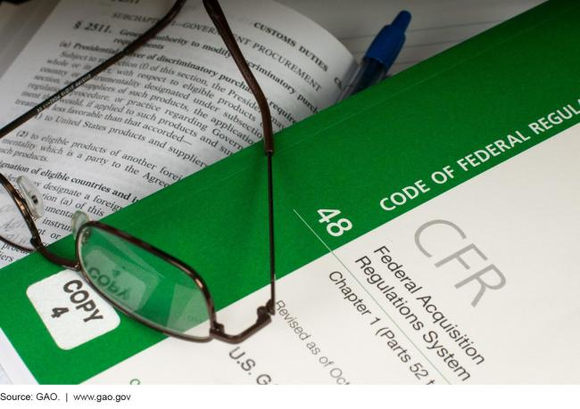 Glasses, pen resting on Code of Federal Regulations