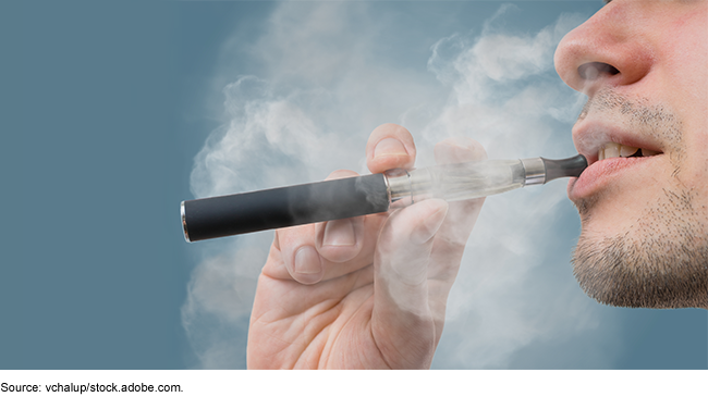A person using an e-cigarette. A person using an e-cigarette.