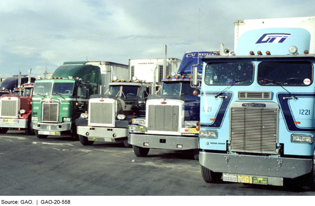 tractor-trailer trucks parked in a lot