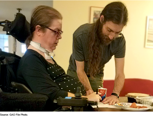 caretaker and woman in wheelchair