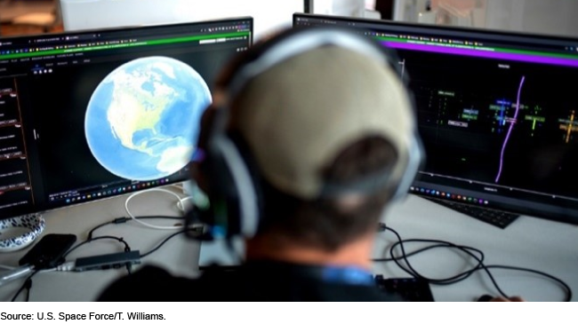 A person looking at planet earth on a computer screen.
