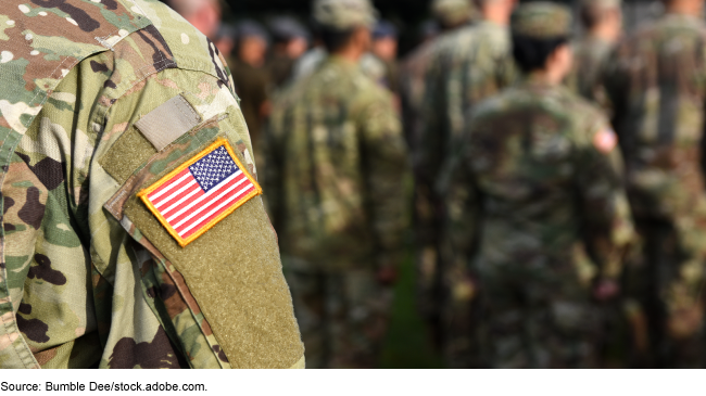 Service member with flag on shoulder.  