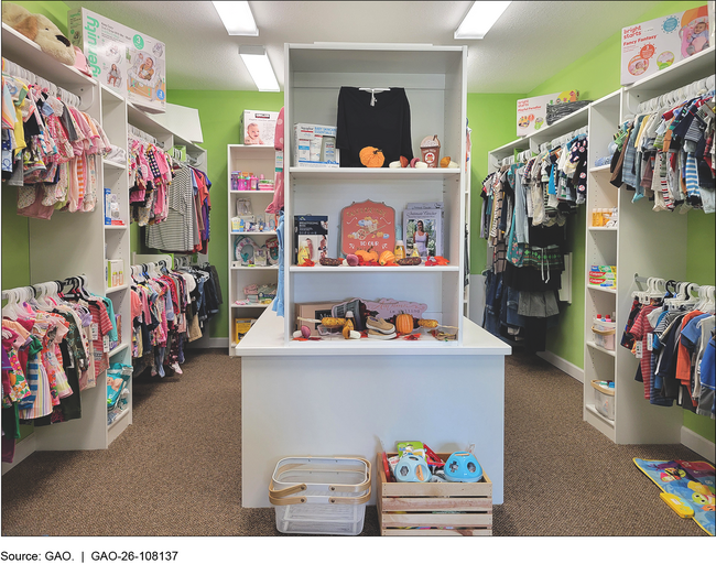 A crisis pregnancy center room with infant supplies, such as clothing, toys, and diapers.
