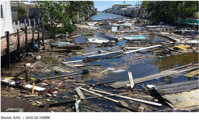 debris floating in water between houses