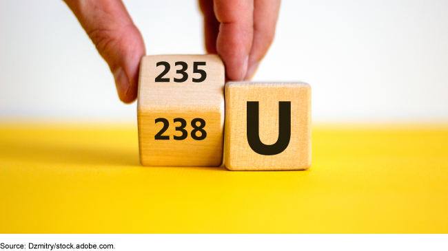 Two wooden blocks. One with the chemical symbol U for uranium; the other with 235 and 238. Two wooden blocks. One with the chemical symbol U for uranium; the other with 235 and 238.