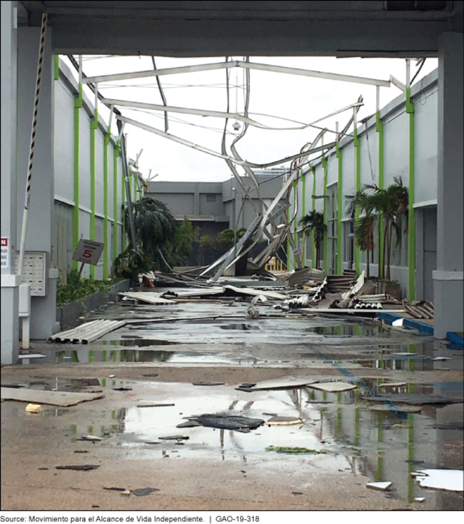 Outdoor space between two buildings littered with materials from the buildings.