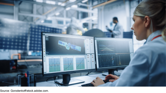 Woman working on a satellite on a computer. Woman working on a satellite on a computer.