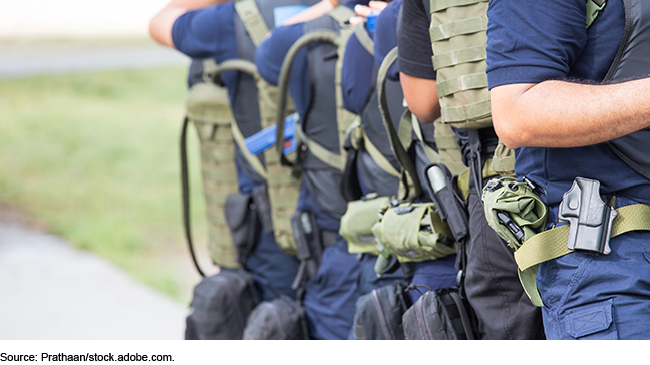 Line of law enforcement personnel wearing gear on a training mission Line of law enforcement personnel wearing gear on a training mission