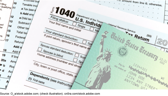 A paper check from the Department of the Treasury on top of a paper copy of the individual tax return Form 1040.