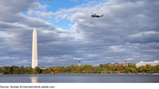 A military helicopter flies past the Washington Monument in Washington, D.C. A military helicopter flies past the Washington Monument in Washington, D.C.