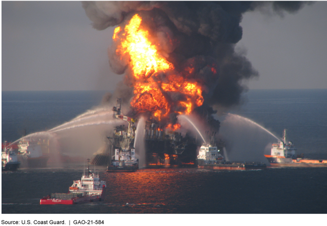 Several Coast Guard vessels spraying water on the Deepwater Horizon oil rig, attempting to put out a massive fire.