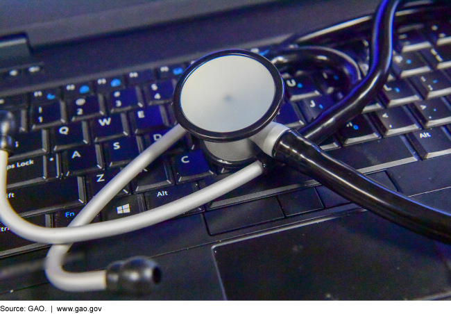 Photo of a stethoscope on a computer keyboard.