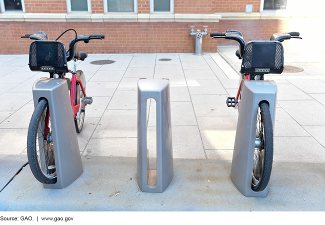 Photo of two bikes docked at a bikeshare station.
