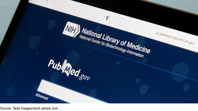 A laptop's web browser visiting the PubMed landing page on the National Institutes of Health website. 