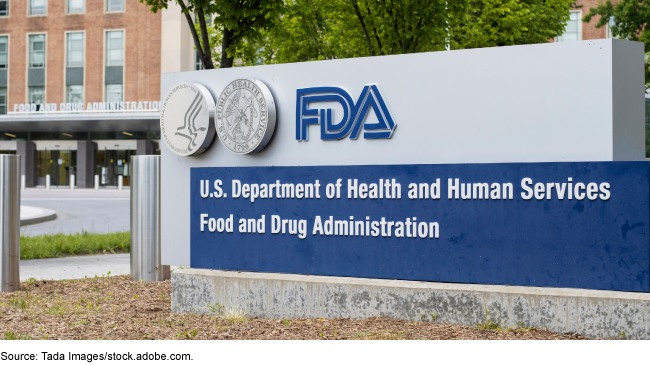 Photograph of the front of the Food and Drug Administration's headquarters building and a sign in the foreground that has the department and agency seals, agency logo, and the words "U.S. Department of Health and Human Services Food and Drug Administration"