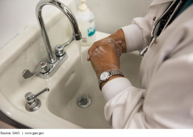 Picture of a medical professional washing her hands.