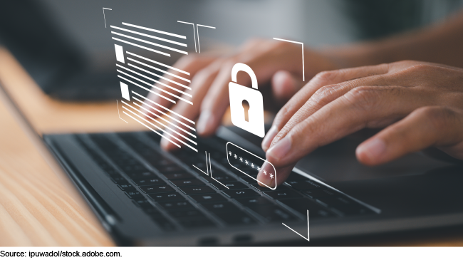 A person typing a password into laptop keyboard with a lock representing data protection.