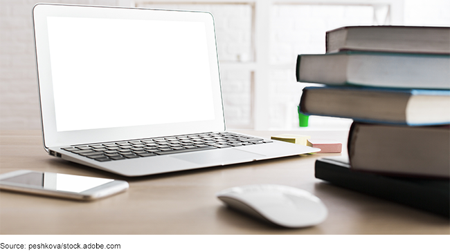 Laptop, smartphone, and books on a desk