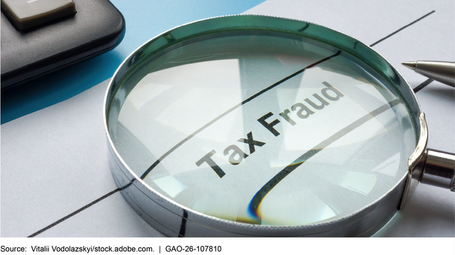 A magnifying glass over the words tax fraud