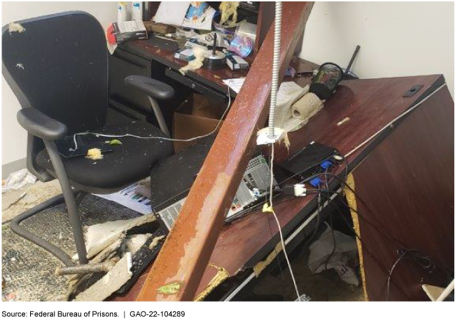 collapsed office desk covered in debris