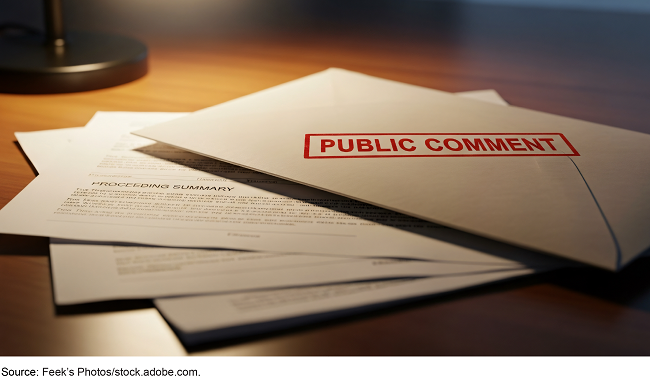 An envelope labeled 'public comment' lays on top of several pages of paper. An envelope labeled 'public comment' lays on top of several pages of paper.