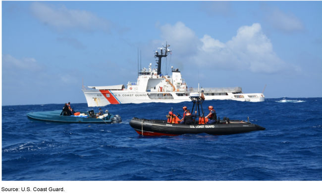 A ship and two smaller boats on the ocean