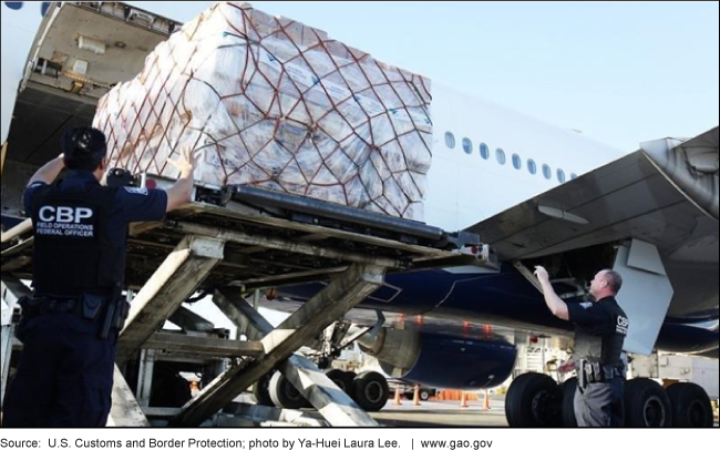 Photo of CBP officers at an airport overseeing shipments