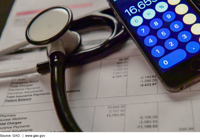 Stethoscope and a calculator on top of a medical bill