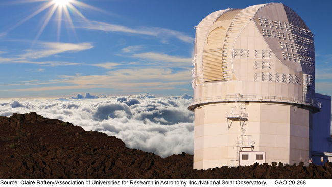 Tower extending above trees and clouds