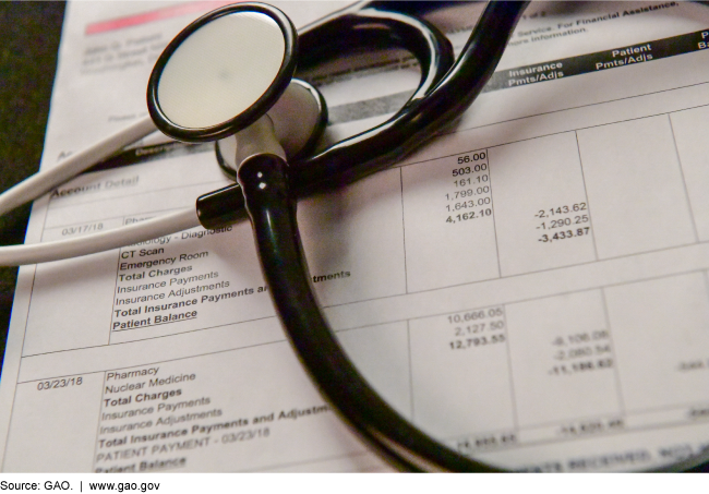 A stethoscope on top of medical bills