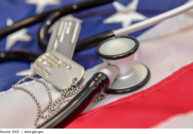 Photo of an American flag with dog tags and a stethoscope resting on it