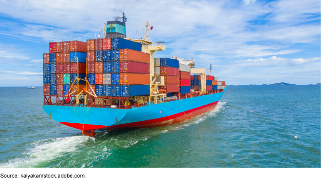 A large cargo ship sailing towards land.