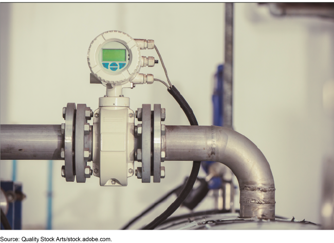 A digital sensor affixed to a metal heat pipe. 