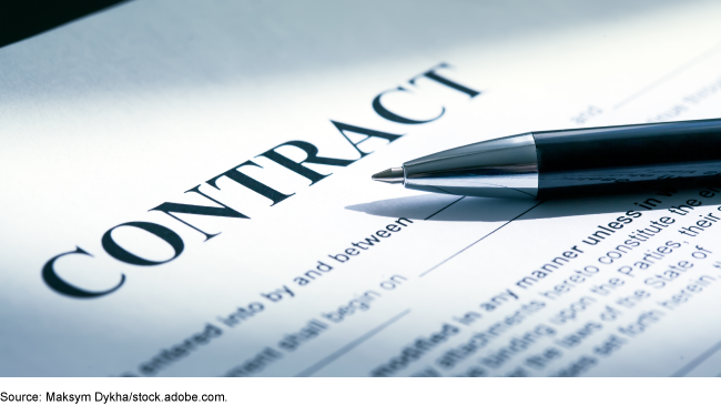 A pen on a paper that says contract.