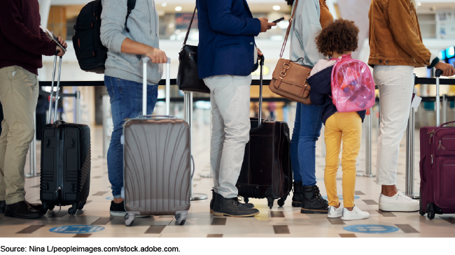 People standing in an immigration line at an airport. People standing in an immigration line at an airport.