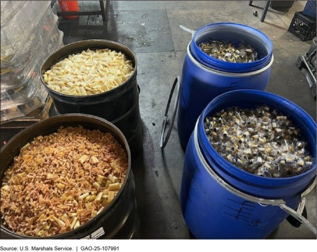 Four large barrels full of pieces of e-cigarettes.