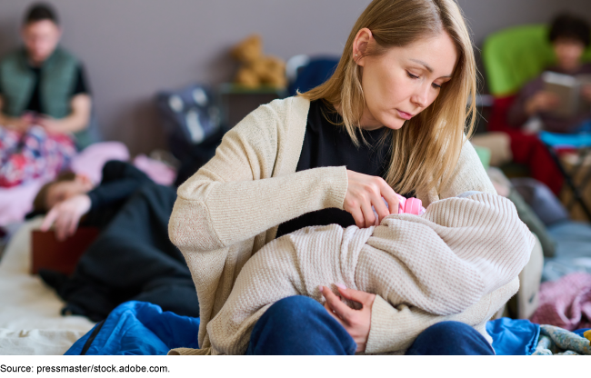 A mother holding and feeding her baby with a bottle.